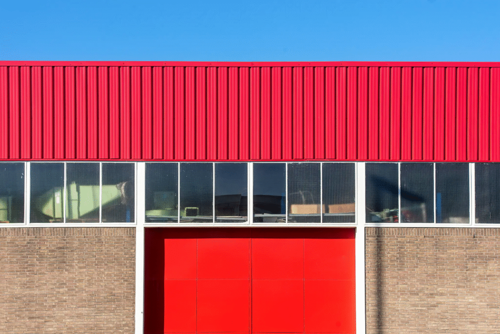 Commercial Exterior Painting Services in Ardmore: What Businesses Need to Know 1 The commercial exterior painting cost for a large warehouse with corrugated metal siding like this is influenced by the surface area and the number of colors used