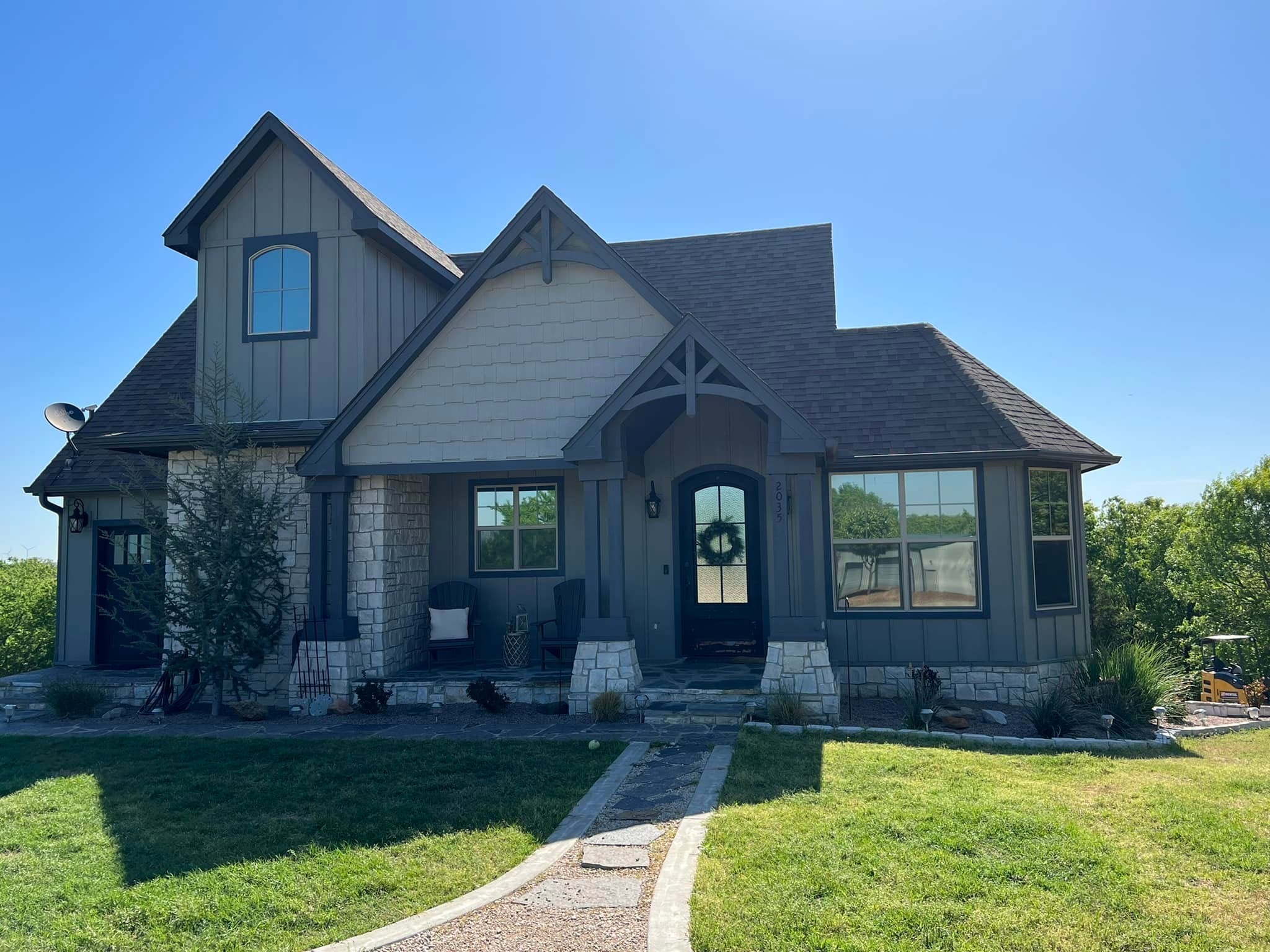 Derheim Painting gray board and batten exterior painting on a Southern Oklahoma home