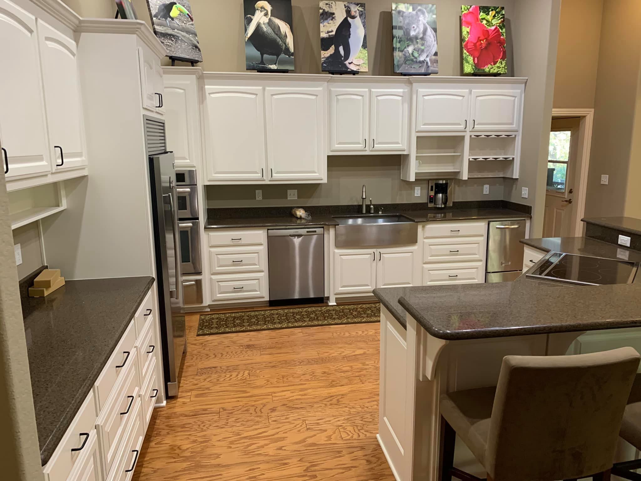 Derheim Painting white cabinet painting with dark granite countertop kitchen in Ardmore, OK