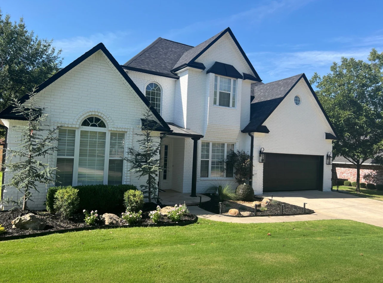 Completed white and black two-story brick home exterior by Derheim Painting